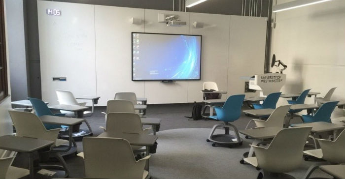 Classroom with 35 mobile all in one chair units and an interactive whiteboard. 