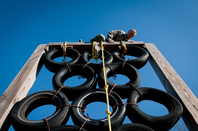 man-89362_640 Man scaling a barrier on an assault course