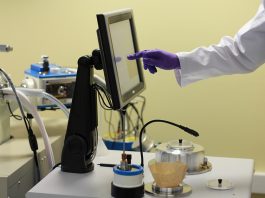 Scientist using electron microscopy equipment