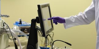 Scientist using electron microscopy equipment