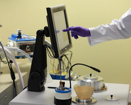 Scientist using electron microscopy equipment