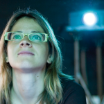 Student watching film projector