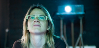 Student watching film projector