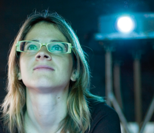Student watching film projector