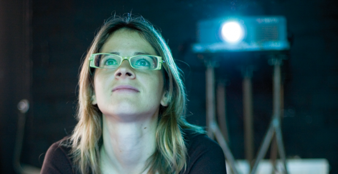 Student watching film projector