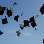 University mortar boards in the air