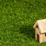 toy wooden house on some grass