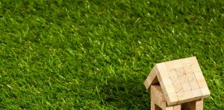 toy wooden house on some grass